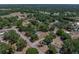 Aerial view of the property showcasing its location within a lush, green neighborhood with mature trees at 3705 Garland St, Mulberry, FL 33860