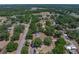 Bird's-eye view of single-story house with a new roof surrounded by lush landscaping and trees at 3705 Garland St, Mulberry, FL 33860