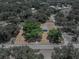 Aerial view of property showing lot boundaries, surrounding trees and single-story house at 3705 Garland St, Mulberry, FL 33860