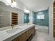 Beautiful bathroom featuring double sinks, wood cabinets, a large mirror and tiled shower and tub at 3705 Garland St, Mulberry, FL 33860