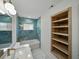 Bright bathroom featuring a shelf, and an elegant tiled shower and tub at 3705 Garland St, Mulberry, FL 33860