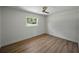 Empty bedroom boasting light walls, modern ceiling fan, and contemporary LVP flooring, flooded with natural light at 3705 Garland St, Mulberry, FL 33860