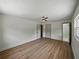Bedroom featuring neutral walls, ceiling fan, modern LVP flooring, multiple doorways, and updated trim work at 3705 Garland St, Mulberry, FL 33860