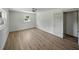 Neutral bedroom featuring an updated ceiling fan, modern LVP flooring, large window, and updated trim work at 3705 Garland St, Mulberry, FL 33860