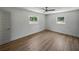 Bright and airy bedroom featuring neutral walls, two large windows, durable LVP flooring, and classic trim at 3705 Garland St, Mulberry, FL 33860