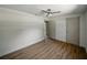 Bedroom with light walls, LVP flooring, ceiling fan, and doorways to other rooms creating an open floor plan at 3705 Garland St, Mulberry, FL 33860