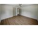 Bedroom with light walls, LVP flooring, ceiling fan, and doorways to other rooms creating an open floor plan at 3705 Garland St, Mulberry, FL 33860