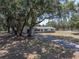 Charming home with mature trees, a long driveway, and a well-maintained front yard at 3705 Garland St, Mulberry, FL 33860