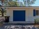 Front exterior view of the home showing the garage with blue door at 3705 Garland St, Mulberry, FL 33860
