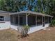 Rear exterior view showing screened in lanai and vinyl siding at 3705 Garland St, Mulberry, FL 33860