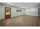 Bright, neutral living room with vinyl flooring, a solid wood front door, and a large window at 3705 Garland St, Mulberry, FL 33860
