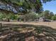 Expansive front yard shaded by mature trees, providing a serene and inviting atmosphere at 3705 Garland St, Mulberry, FL 33860