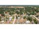 A drone shot of a home in its suburban surroundings surrounded by tall trees at 400 6Th Ne St, Fort Meade, FL 33841