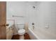 A vintage bathroom with white tile, a bathtub and shower, and a dated vanity and toilet at 400 6Th Ne St, Fort Meade, FL 33841