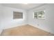 Bright bedroom featuring neutral carpet and natural light from two windows with blinds at 400 6Th Ne St, Fort Meade, FL 33841