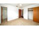 Bright bedroom offering neutral carpet, ceiling fan, closet, and easy bathroom access at 400 6Th Ne St, Fort Meade, FL 33841
