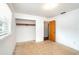A bright bedroom with neutral carpet, an open closet, and a door leading to another room at 400 6Th Ne St, Fort Meade, FL 33841