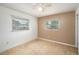 Cozy bedroom featuring neutral carpet, ceiling fan, and natural light from two windows at 400 6Th Ne St, Fort Meade, FL 33841