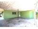 View of large carport with concrete flooring, green exterior, and white trim at 400 6Th Ne St, Fort Meade, FL 33841