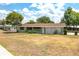 Quaint single-story home with a green exterior, brown roof, and a well-maintained front yard at 400 6Th Ne St, Fort Meade, FL 33841