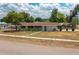 Charming single-story home with a green exterior, brown roof, and a front yard at 400 6Th Ne St, Fort Meade, FL 33841