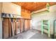 View of the unfinished garage featuring exposed studs, wood ceiling and shelving at 400 6Th Ne St, Fort Meade, FL 33841