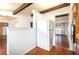 Kitchen with white refrigerator and wood-look floors, seamlessly connected to a living space at 400 6Th Ne St, Fort Meade, FL 33841