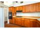 Functional kitchen featuring wood cabinets, laminate countertops, and essential appliances at 400 6Th Ne St, Fort Meade, FL 33841