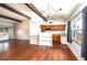 Sunlit living room with hardwood floors, beamed ceilings, and an open layout to the kitchen at 400 6Th Ne St, Fort Meade, FL 33841