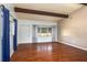 Spacious living room with hardwood floors, vaulted ceilings, and exposed beams at 400 6Th Ne St, Fort Meade, FL 33841