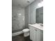 Bathroom featuring a shower with a marble tile and a vanity with a white cabinet at 4058 Oak Loop # 99, Mulberry, FL 33860
