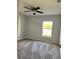 Neutral bedroom with a large window, carpet floors, and a ceiling fan at 4058 Oak Loop # 99, Mulberry, FL 33860