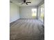 A spacious bedroom featuring a large window, carpet floors, and a ceiling fan at 4058 Oak Loop # 99, Mulberry, FL 33860