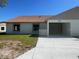 Home exterior featuring an attached garage, concrete driveway, and green lawn at 4058 Oak Loop # 99, Mulberry, FL 33860