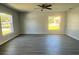 A spacious living room featuring multiple windows, hardwood floors, and a ceiling fan at 4058 Oak Loop # 99, Mulberry, FL 33860