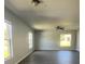Bright and spacious living room featuring wood floors, a ceiling fan, and natural lighting at 4058 Oak Loop # 99, Mulberry, FL 33860