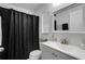 Cozy bathroom offering a shower with black curtain, vanity with storage, and a framed mirror at 4078 Winding Vine Dr, Lakeland, FL 33812