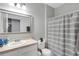 This bathroom features a vanity with a sink, mirror, toilet and shower at 4078 Winding Vine Dr, Lakeland, FL 33812