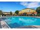 Community pool with lounge chairs and a view of the surrounding townhome community at 4078 Winding Vine Dr, Lakeland, FL 33812