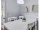 Bright dining room features white table and chairs, modern art, and a minimalist style at 4078 Winding Vine Dr, Lakeland, FL 33812