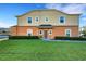 Charming townhome with neat lawn and lake view, featuring a covered front entry and manicured shrubs at 4078 Winding Vine Dr, Lakeland, FL 33812