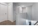 Upstairs hallway with multiple doors and carpeting throughout at 4078 Winding Vine Dr, Lakeland, FL 33812