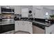 This kitchen has stainless steel appliances, dark counters, and white cabinets at 4078 Winding Vine Dr, Lakeland, FL 33812