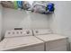 Laundry room with washer, dryer, and storage shelf at 4078 Winding Vine Dr, Lakeland, FL 33812