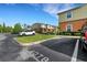 View of building with parking lot in front, with a row of townhomes in the background at 4078 Winding Vine Dr, Lakeland, FL 33812