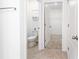 Bathroom view to toilet and walk-in closet featuring neutral paint and flooring at 4203 San Rocco Way, Winter Haven, FL 33884