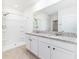 Bright bathroom features granite countertops, double sinks, tiled floor and walk-in shower at 4203 San Rocco Way, Winter Haven, FL 33884