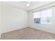 Bright carpeted bedroom features a ceiling fan and a sunlit window at 4203 San Rocco Way, Winter Haven, FL 33884