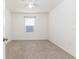 Neutral carpeted bedroom with ceiling fan and window allows for comfort and natural light at 4203 San Rocco Way, Winter Haven, FL 33884