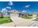 Traditional home exterior with a two-car garage, long driveway and well maintained landscaping at 4203 San Rocco Way, Winter Haven, FL 33884